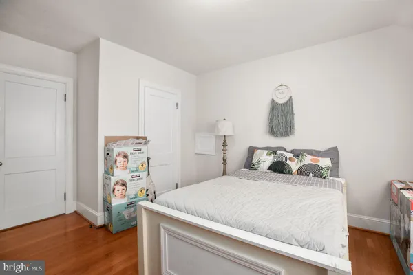 a bedroom with a bed and a wooden floor