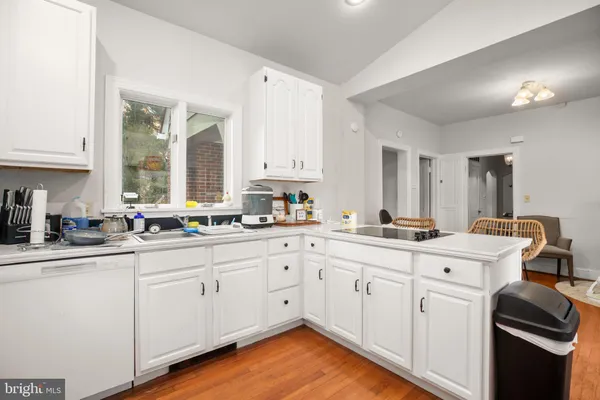 a kitchen with white cabinets sink and white appliances