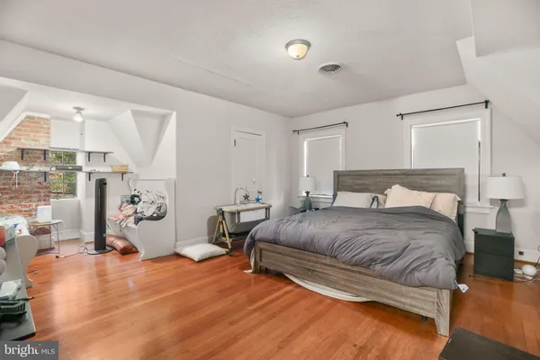 a spacious bedroom with a bed and a table