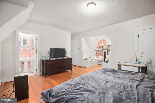 a bedroom with a bed and a television