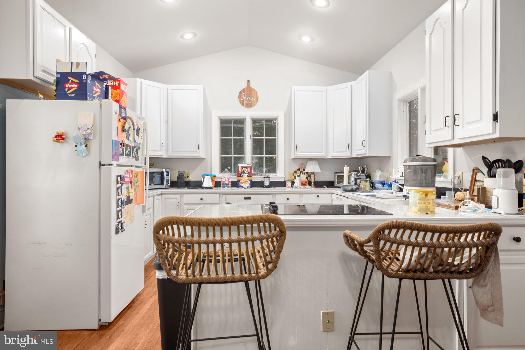 1717 Highland Road Fredericksburg, VA 22401 - Photo 4 of 40 a kitchen with stainless steel appliances granite countertop a refrigerator a sink a stove and white cabinets
