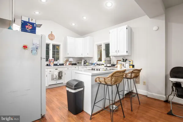 a kitchen with stainless steel appliances kitchen island granite countertop a sink and cabinets