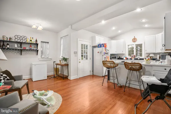 a living room with furniture and kitchen view