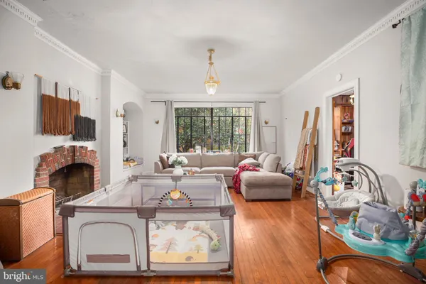 a living room with fireplace furniture and a large window