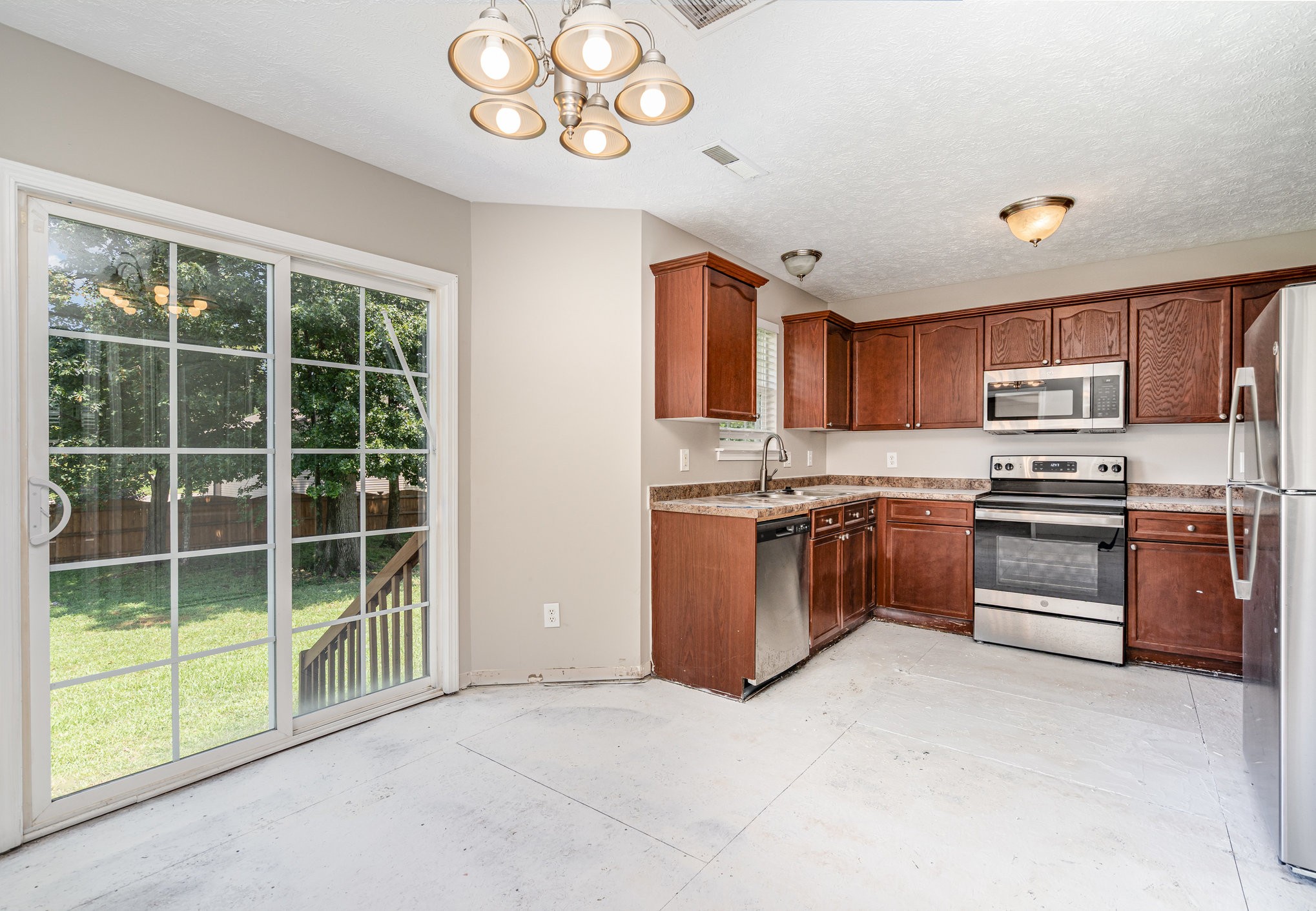 103 Chapel Brook Way Murfreesboro, TN 37129 - Photo 4 of 23 a kitchen with a stove a sink and a microwave