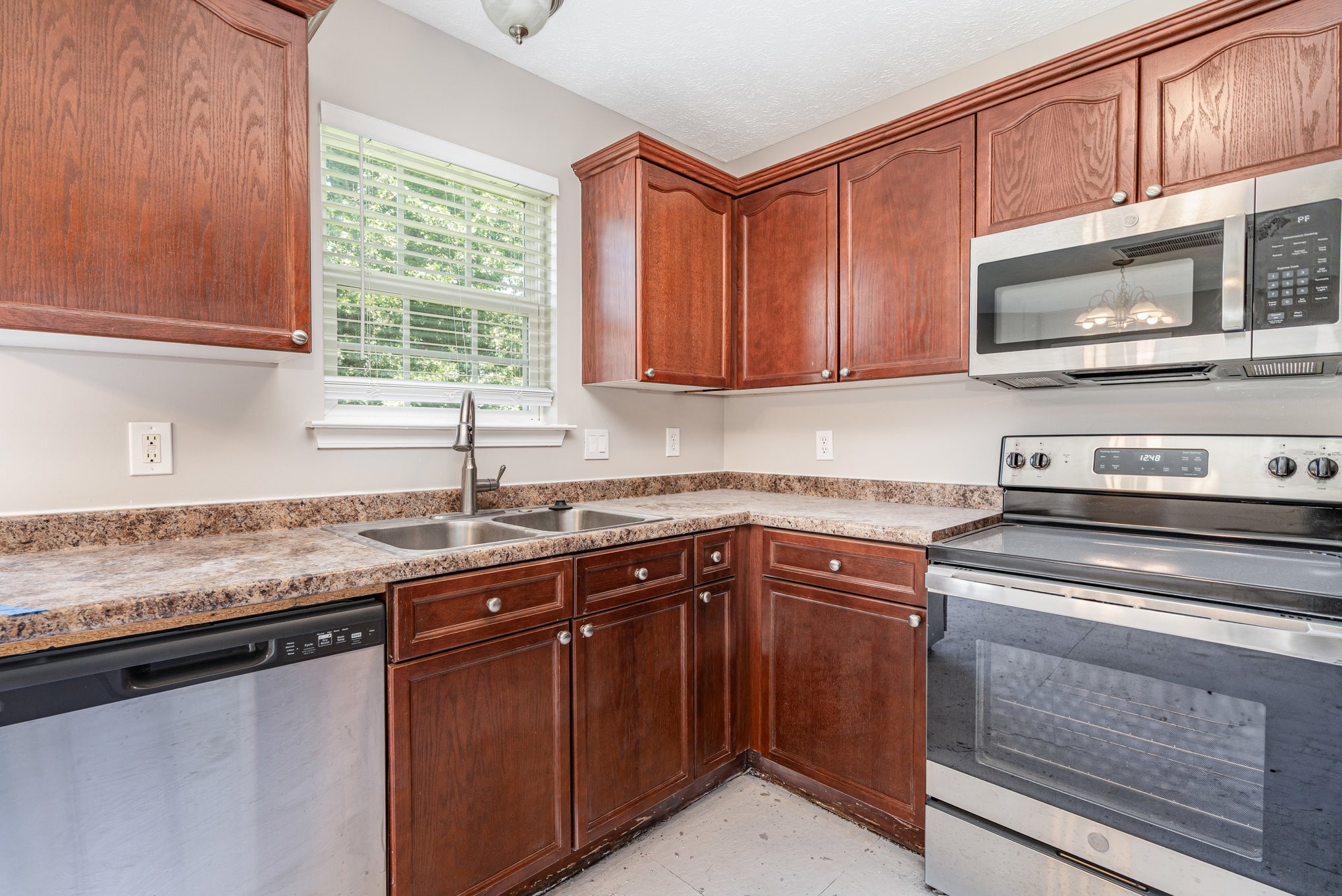 103 Chapel Brook Way Murfreesboro, TN 37129 - Photo 5 of 23 a kitchen with stainless steel appliances granite countertop a sink stove and microwave