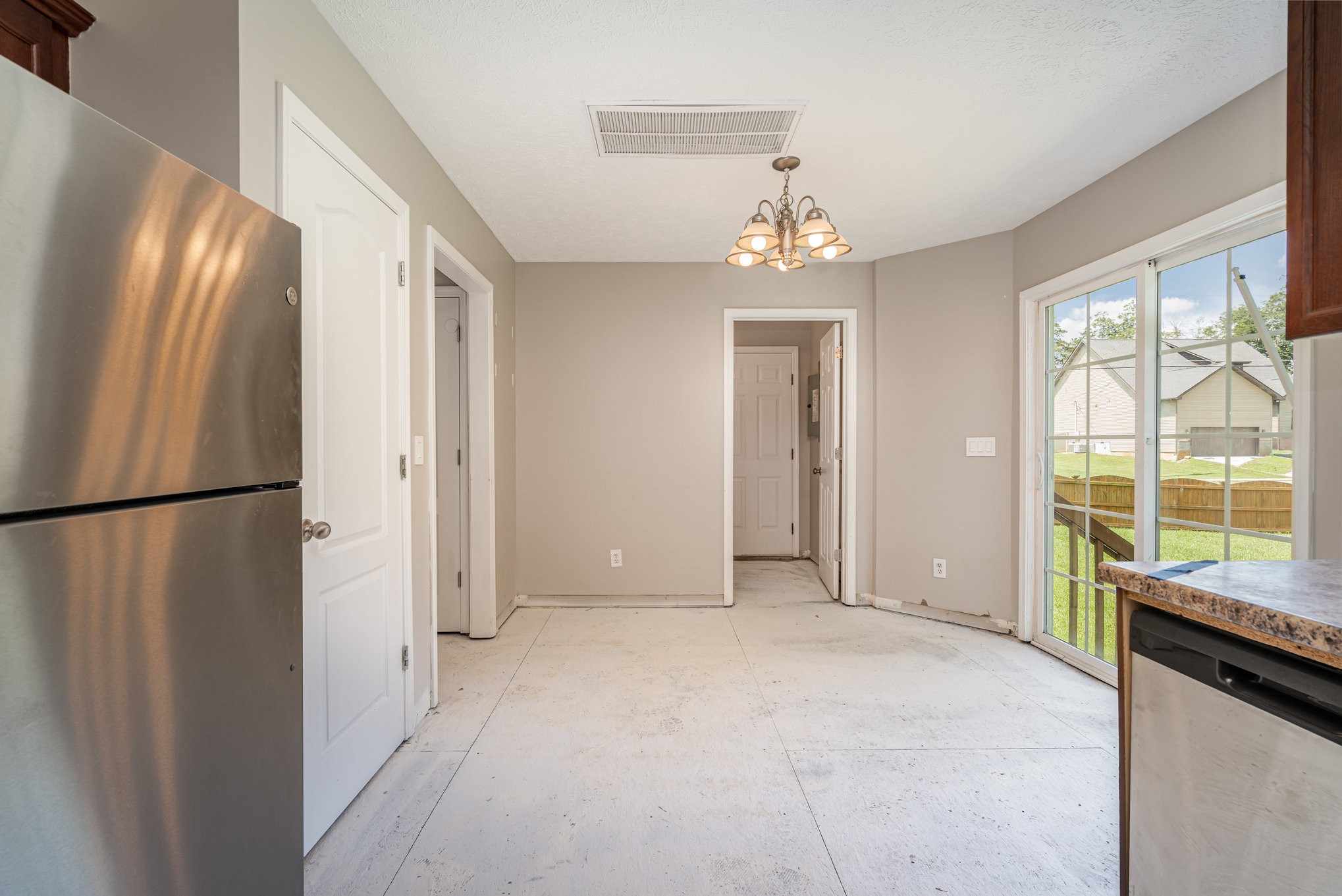 103 Chapel Brook Way Murfreesboro, TN 37129 - Photo 7 of 23 a view of a refrigerator in kitchen and an empty room