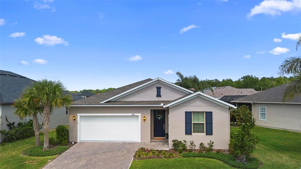 a front view of a house with a yard and garage