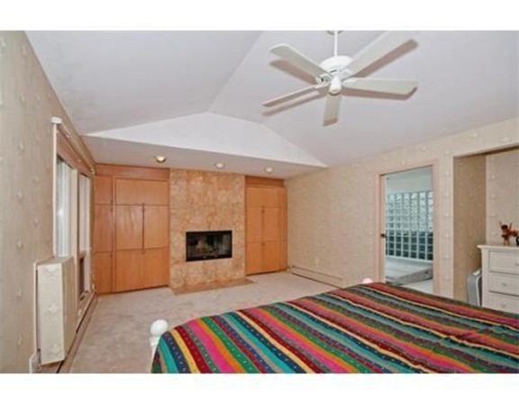 15 Cross Hill Road Newton, MA 02459 - Photo 18 of 25 a bedroom with a bed and a chandelier