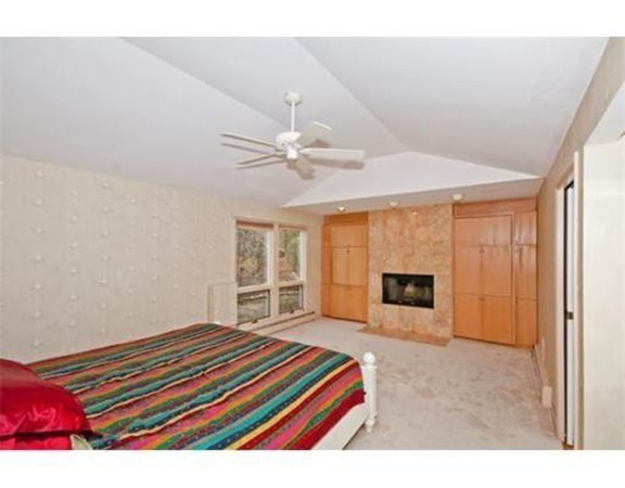 15 Cross Hill Road Newton, MA 02459 - Photo 19 of 25 a room with a bed and a chandelier