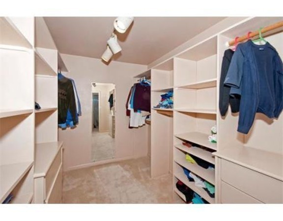 15 Cross Hill Road Newton, MA 02459 - Photo 20 of 25 a view of walk in closet with clothes and shoes