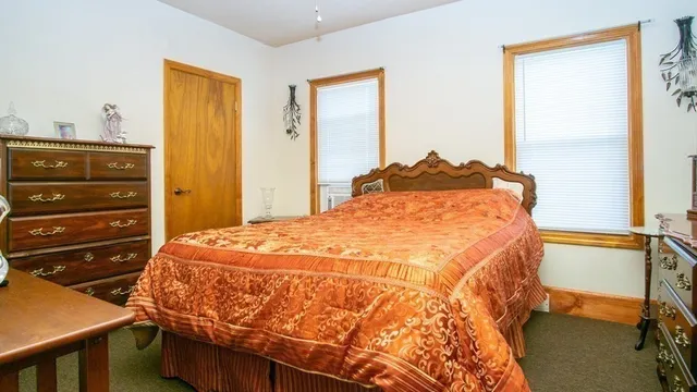 a bed sitting in a bedroom next to a window