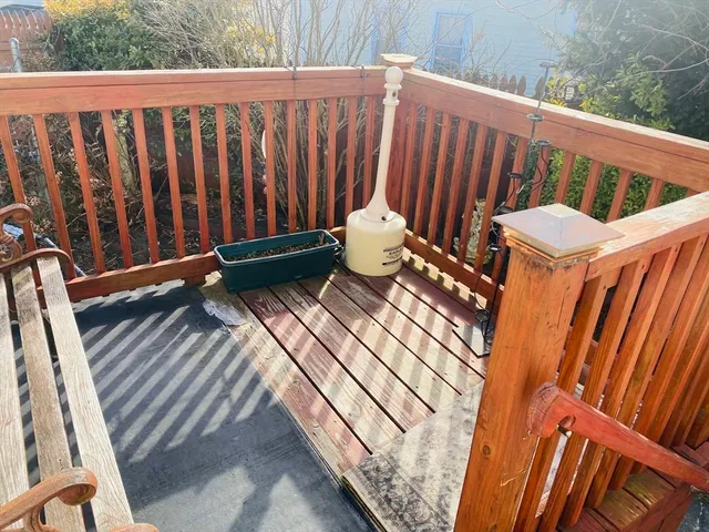 a view of a wooden bench in the back yard