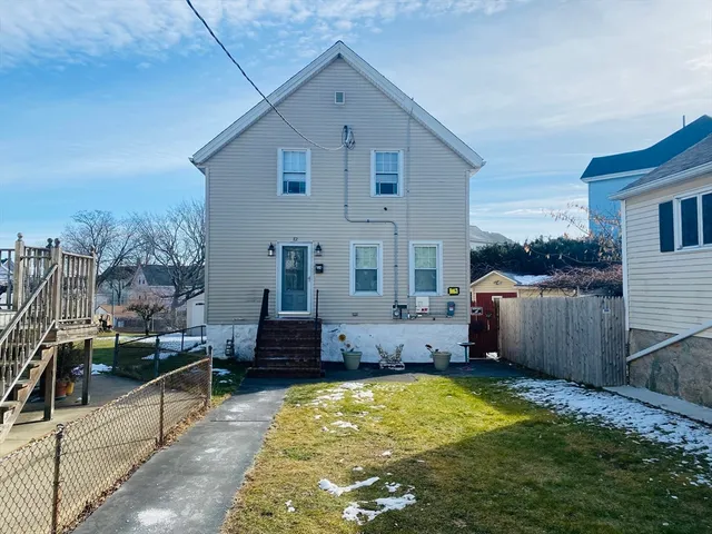 a view of a house with a backyard and a patio