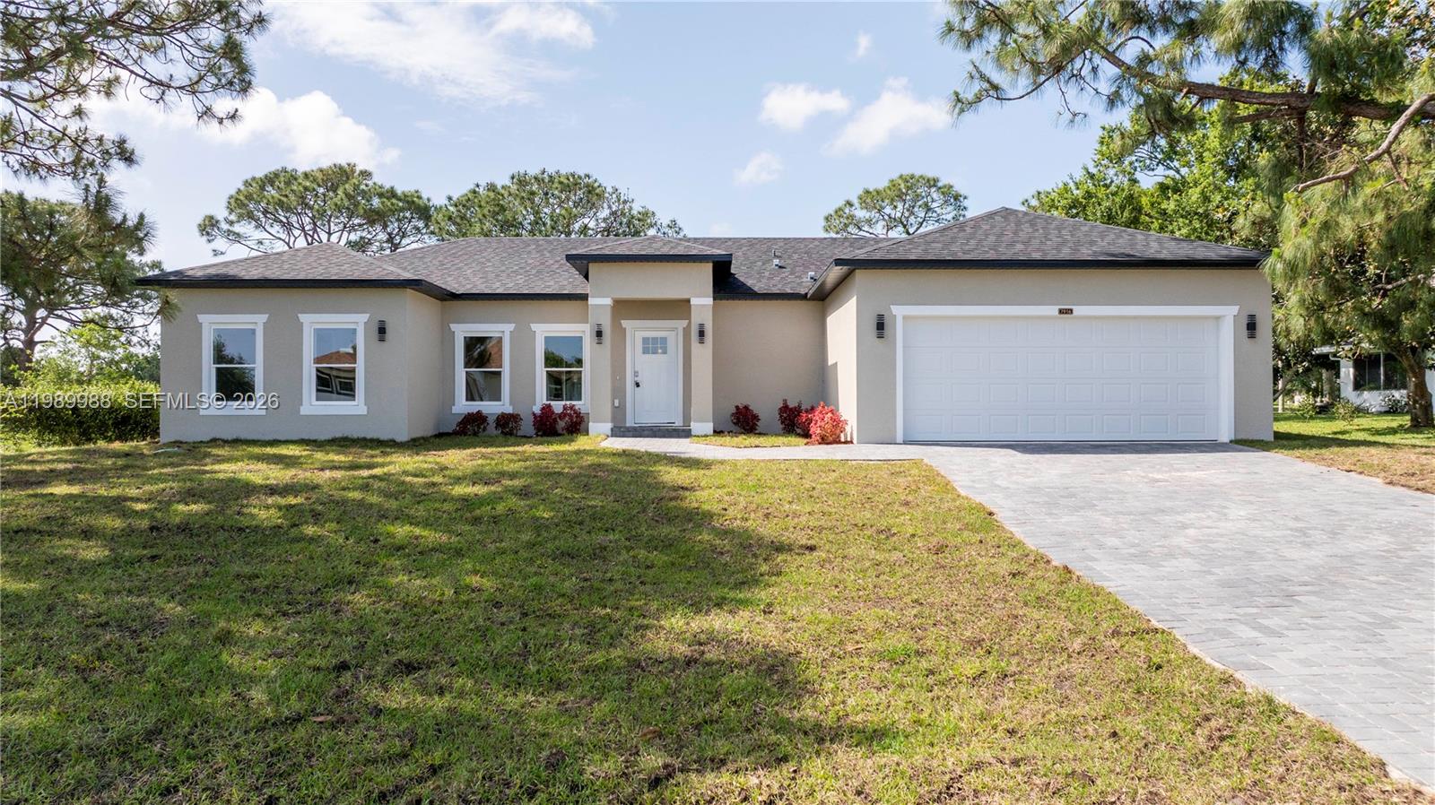 7916 Granada Road Sebring, FL 33876 - Photo 1 of 60 a front view of a house with a yard and garage