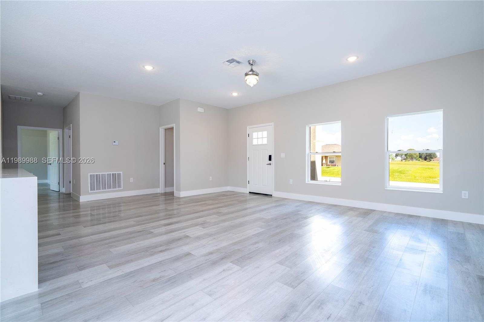7916 Granada Road Sebring, FL 33876 - Photo 18 of 60 a view of empty room with wooden floor and window