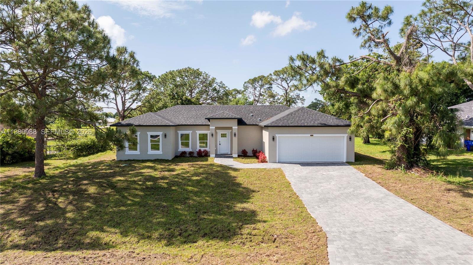 7916 Granada Road Sebring, FL 33876 - Photo 2 of 60 a front view of a house with garden