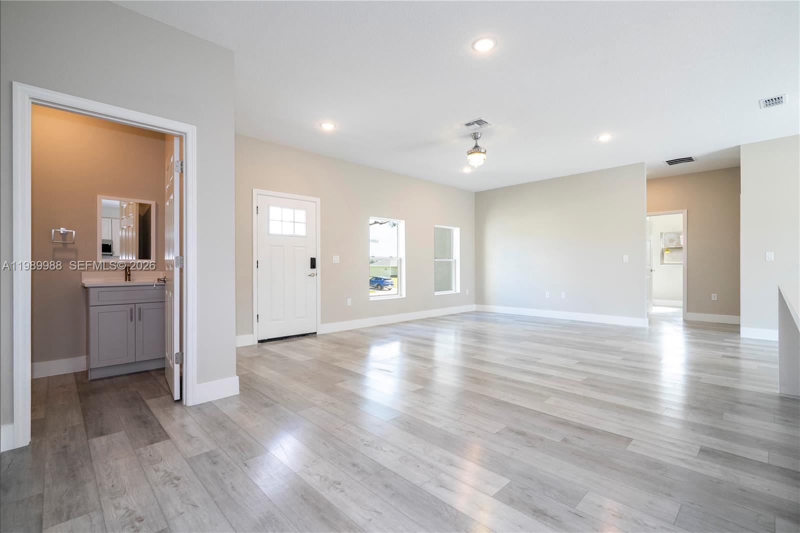 7916 Granada Road Sebring, FL 33876 - Photo 25 of 60 a view of a big room with wooden floor and windows