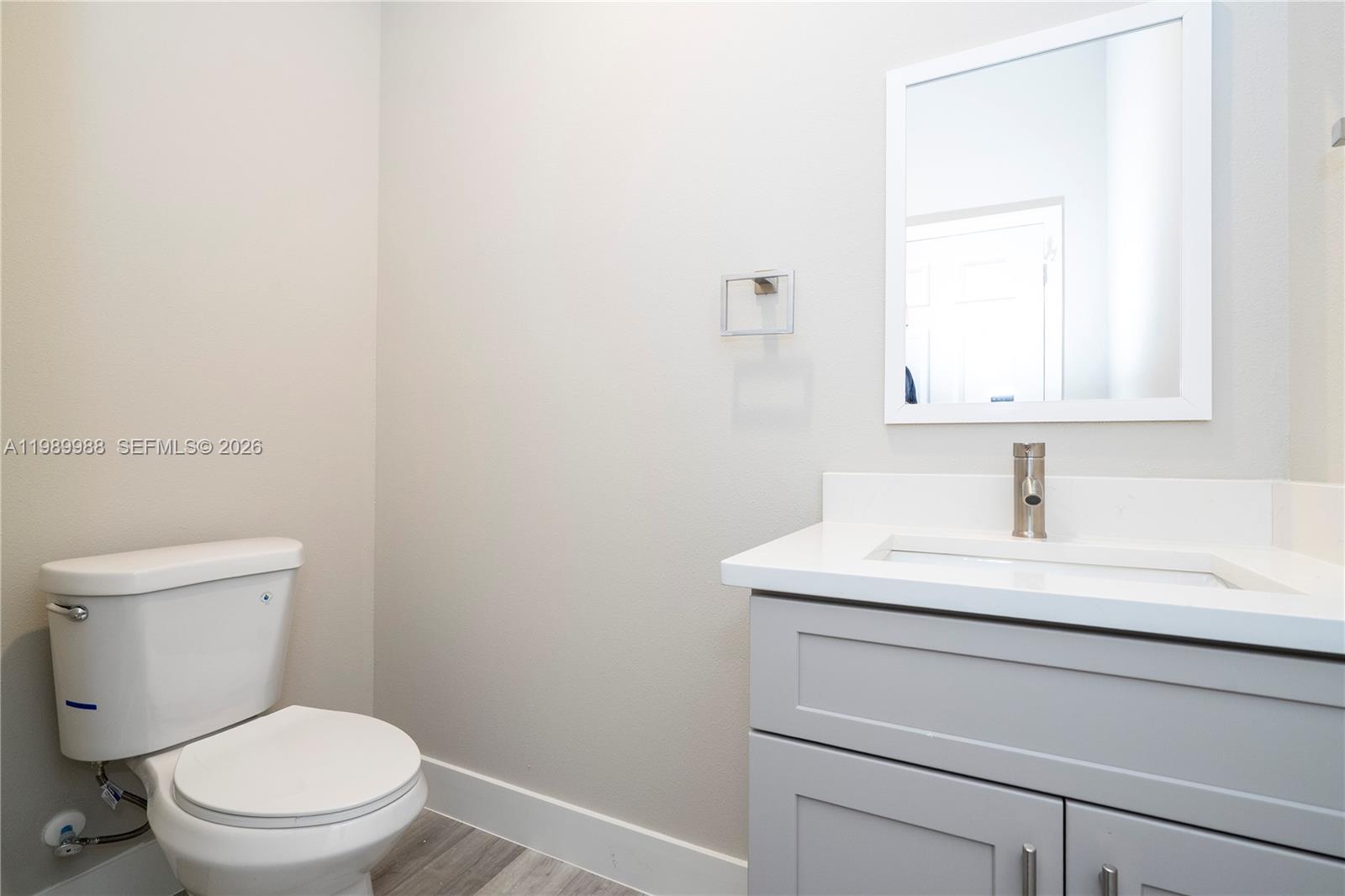 7916 Granada Road Sebring, FL 33876 - Photo 28 of 60 a bathroom with a toilet sink and mirror