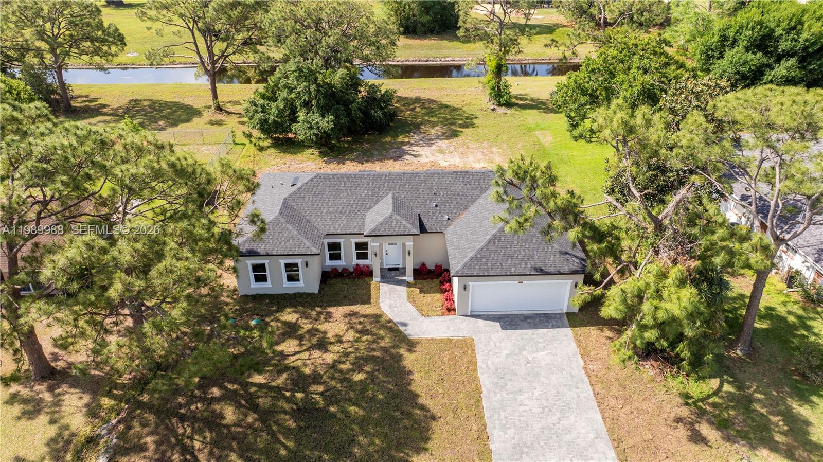 7916 Granada Road Sebring, FL 33876 - Photo 3 of 60 an aerial view of a house with a yard big trees