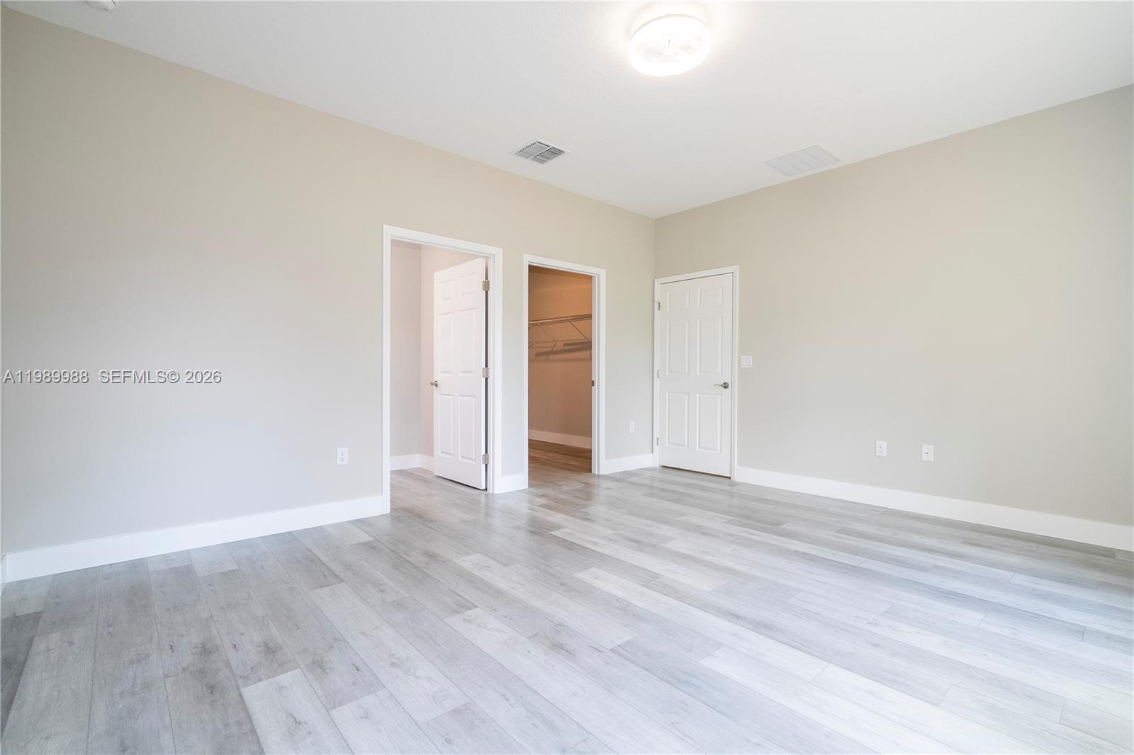 7916 Granada Road Sebring, FL 33876 - Photo 32 of 60 a view of an empty room with wooden floor