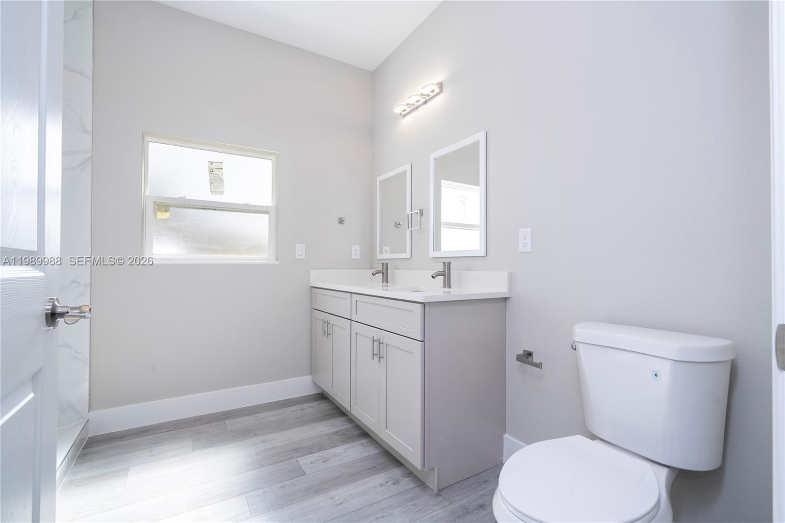 7916 Granada Road Sebring, FL 33876 - Photo 46 of 60 a bathroom with a toilet sink and mirror