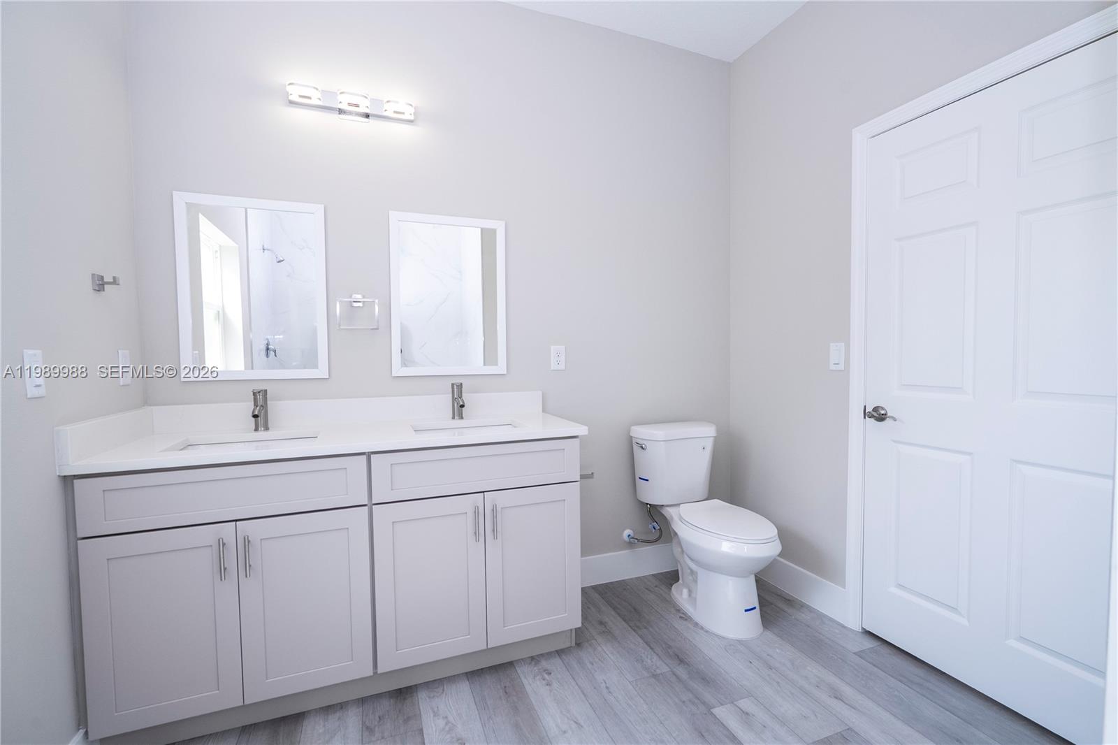 7916 Granada Road Sebring, FL 33876 - Photo 50 of 60 a bathroom with a toilet sink and a mirror