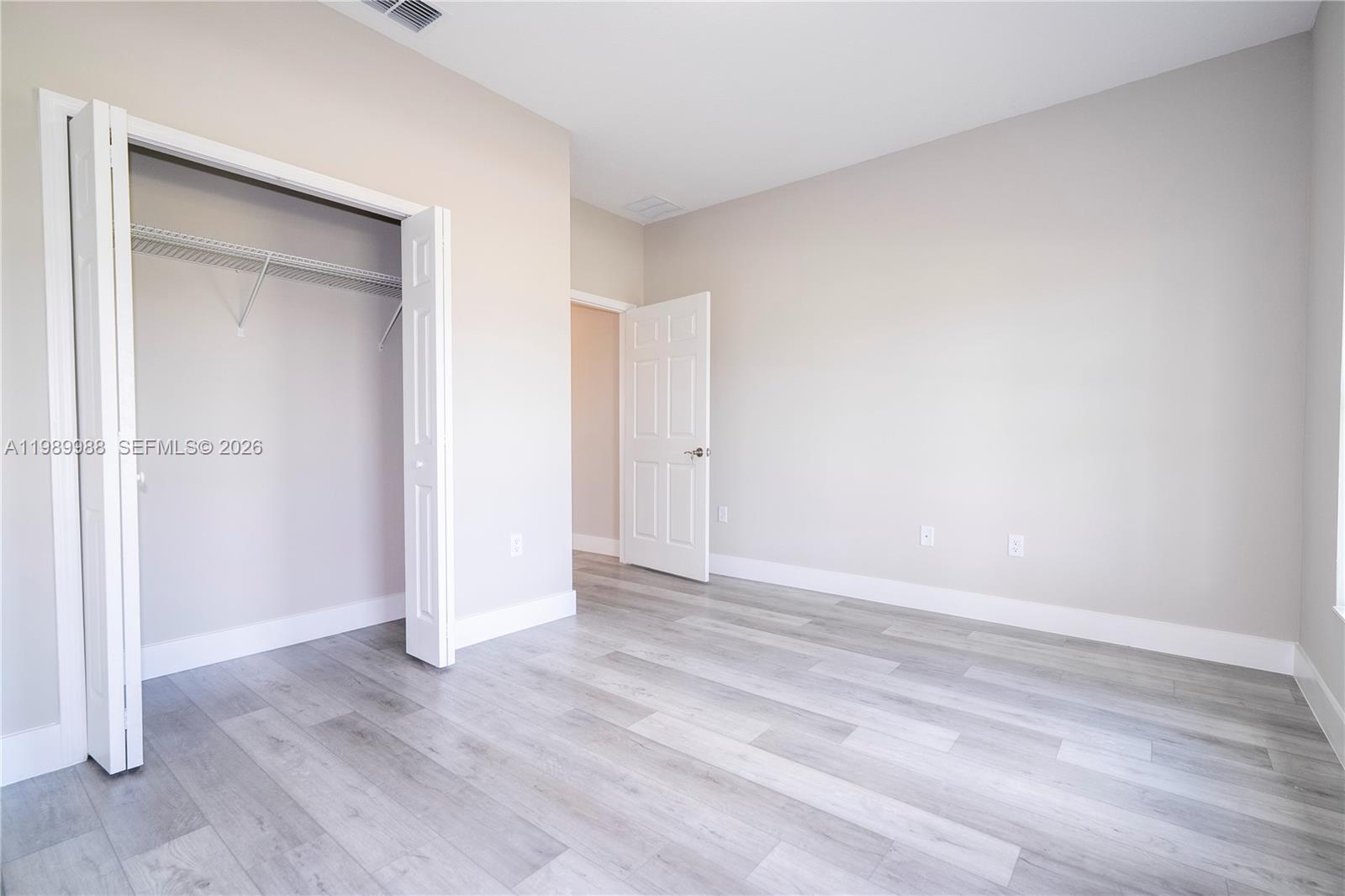 7916 Granada Road Sebring, FL 33876 - Photo 53 of 60 an empty room with wooden floor & closet area
