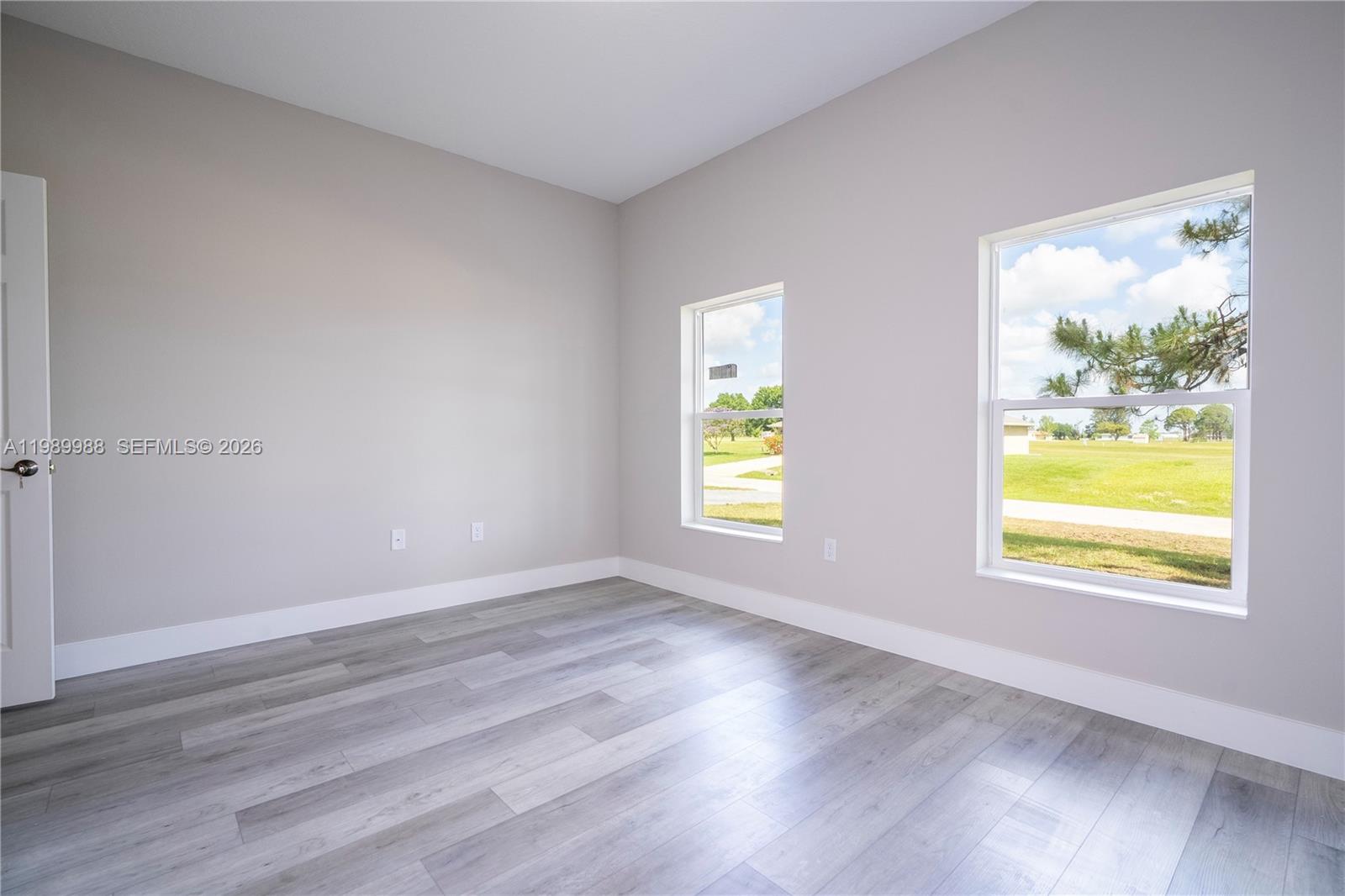 7916 Granada Road Sebring, FL 33876 - Photo 54 of 60 a view of an empty room with wooden floor and a window