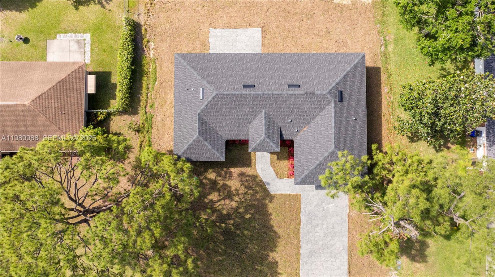 7916 Granada Road Sebring, FL 33876 - Photo 6 of 60 aerial view of a house with a yard and large trees