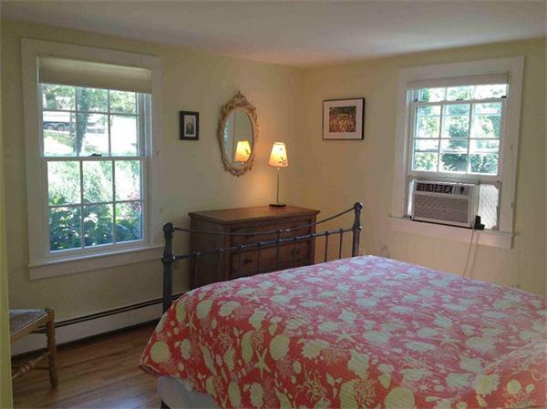 58 Doane Road Chatham, MA 02633 - Photo 11 of 24 a bed sitting in a bedroom next to a window