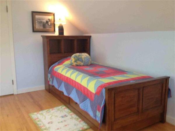 58 Doane Road Chatham, MA 02633 - Photo 15 of 24 a bedroom with a bed and a dresser