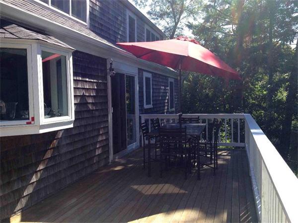 58 Doane Road Chatham, MA 02633 - Photo 19 of 24 a balcony with wooden floor table and chairs