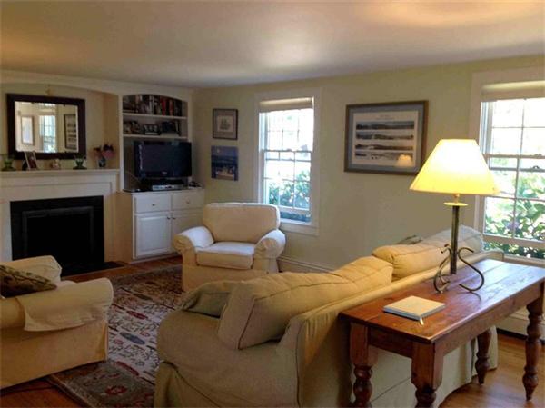 58 Doane Road Chatham, MA 02633 - Photo 4 of 24 a living room with furniture a flat screen tv and a fireplace