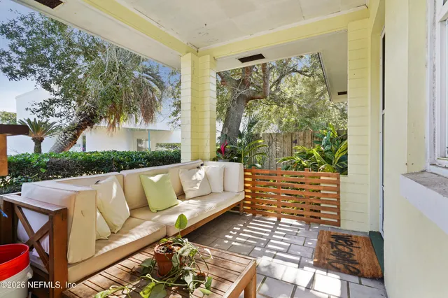 a view of a backyard with table and chairs and a barbeque