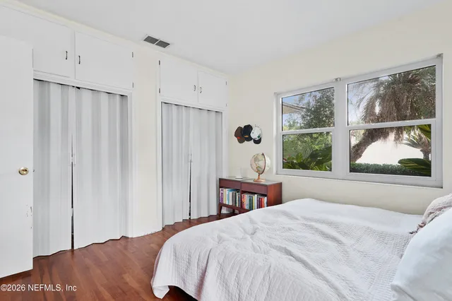 a bedroom with a large bed and a window