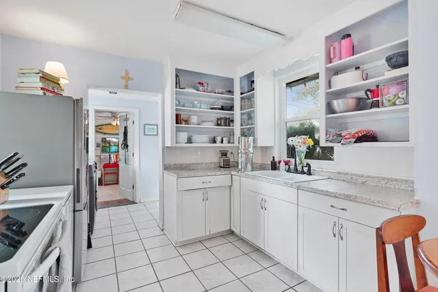 a kitchen with appliances cabinets and a sink