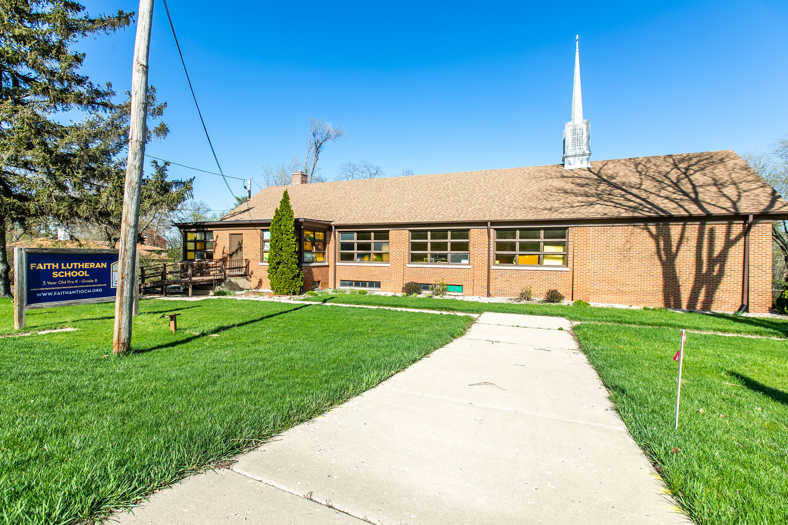 1275 Main Street Antioch, IL 60002 - Photo 2 of 29 a view of a house with a big yard potted plants and large tree