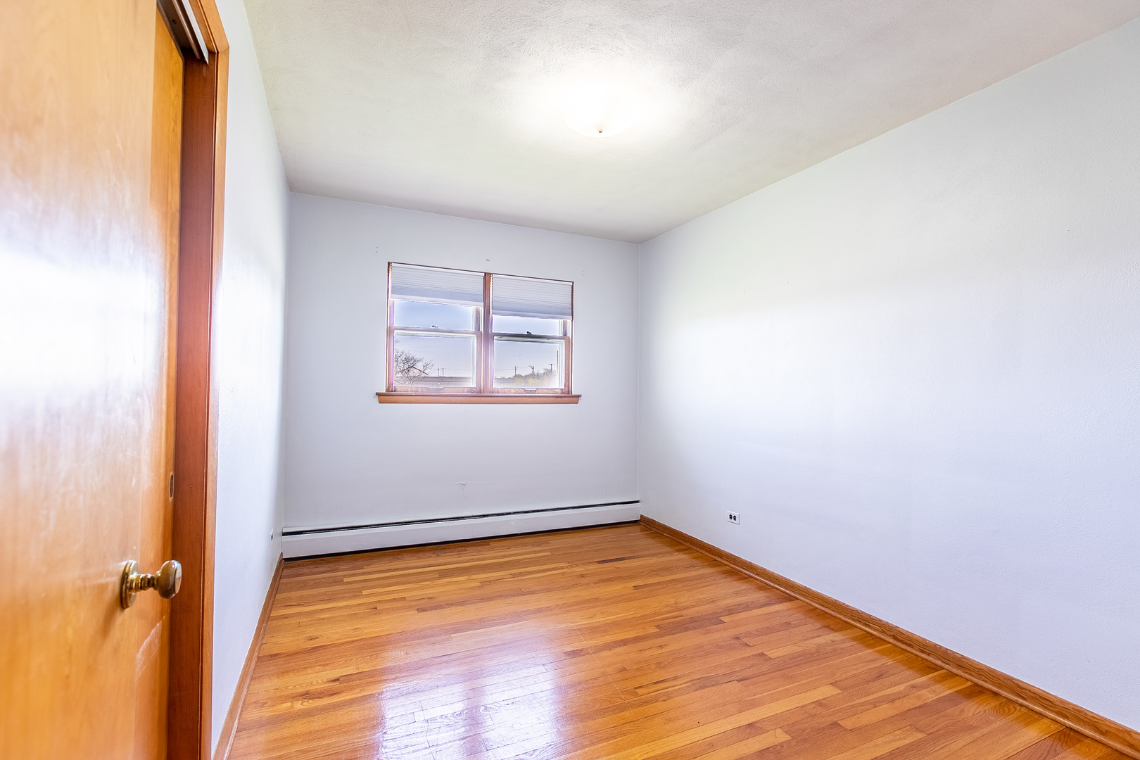 1275 Main Street Antioch, IL 60002 - Photo 25 of 29 an empty room with a wooden floor and a window