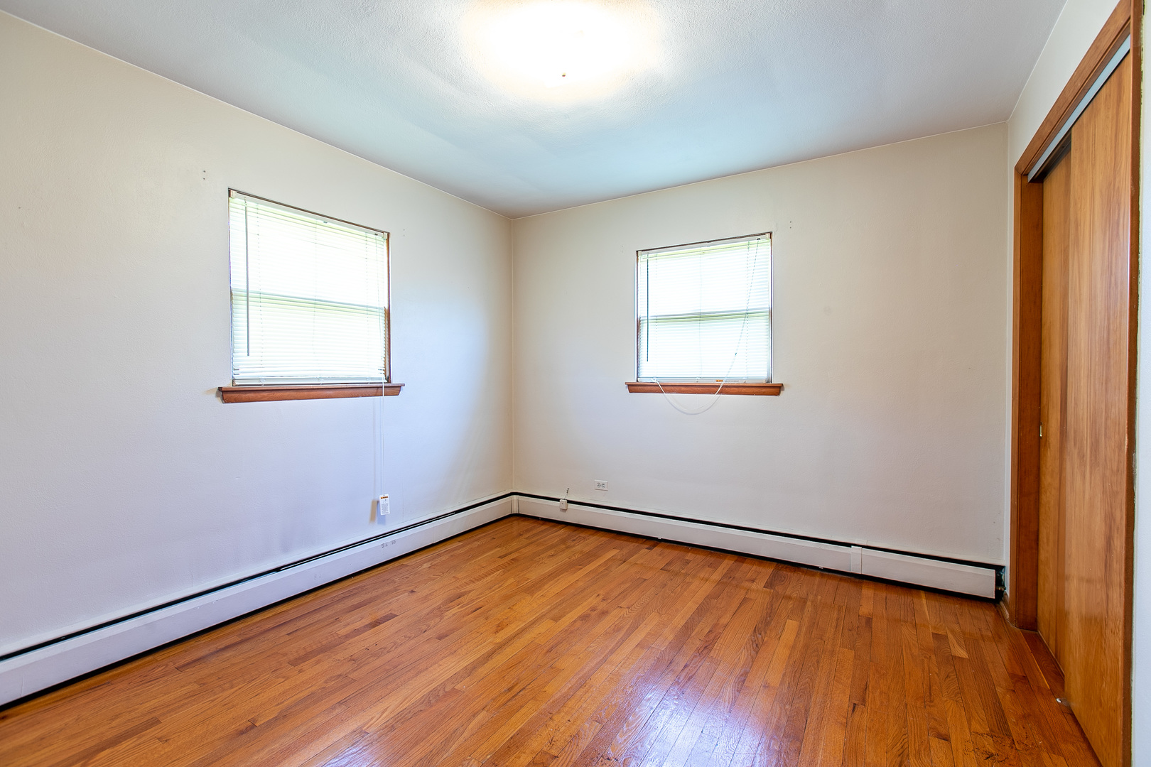 1275 Main Street Antioch, IL 60002 - Photo 26 of 29 an empty room with wooden floor and windows