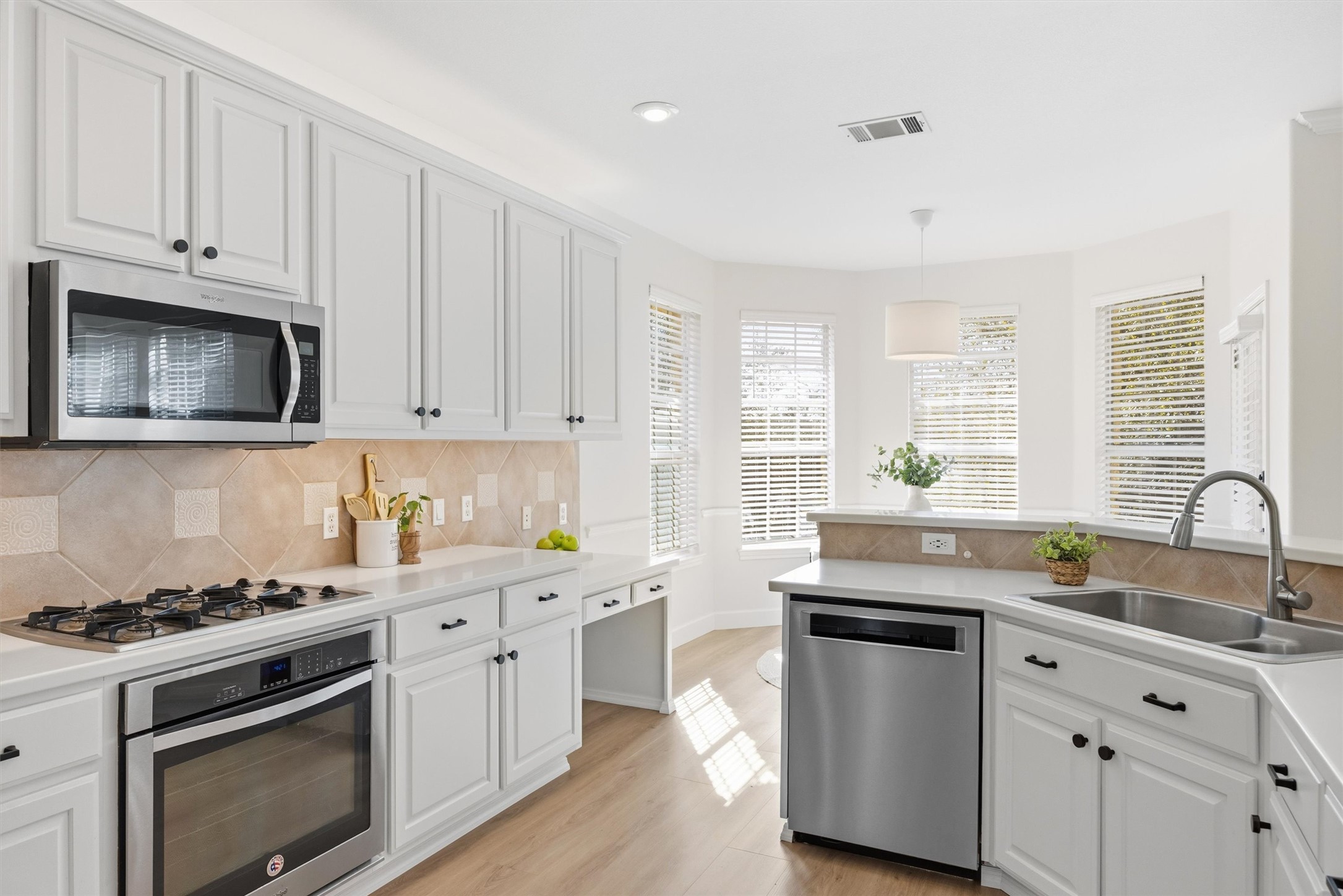 9400 Savannah Ridge Drive Austin, TX 78726 - Photo 17 of 35 a kitchen with granite countertop white cabinets and stainless steel appliances