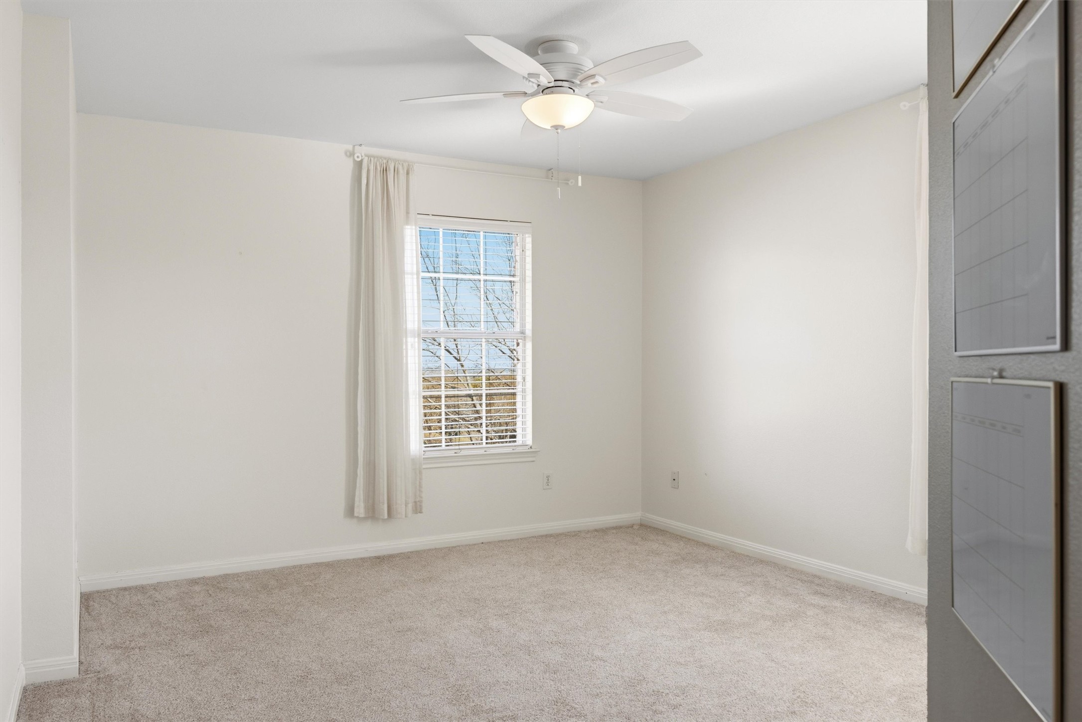 9400 Savannah Ridge Drive Austin, TX 78726 - Photo 27 of 35 an empty room with a window and a ceiling fan