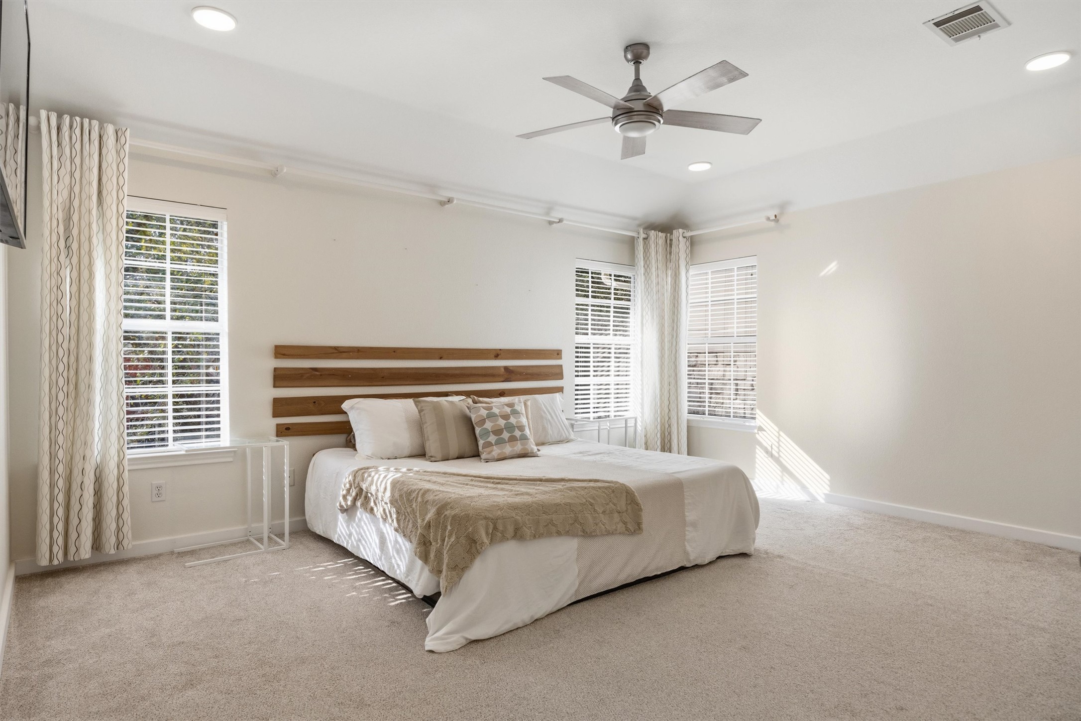 9400 Savannah Ridge Drive Austin, TX 78726 - Photo 30 of 35 a bedroom with a bed chandelier and a large window