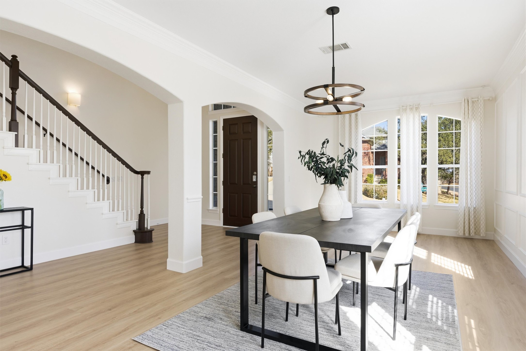 9400 Savannah Ridge Drive Austin, TX 78726 - Photo 9 of 35 a dining room with wooden floor a chandelier a wooden table and chairs