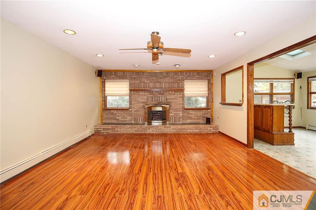 53 Hillsdale Road Edison, NJ 08820 - Photo 11 of 25 a view of empty room with a fireplace and wooden floor