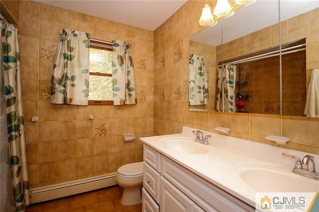 53 Hillsdale Road Edison, NJ 08820 - Photo 18 of 25 a bathroom with a sink a toilet and shower