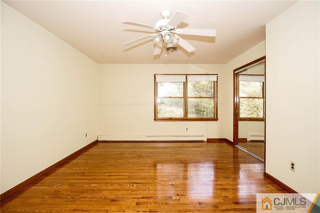53 Hillsdale Road Edison, NJ 08820 - Photo 19 of 25 wooden floor in an empty room with a window