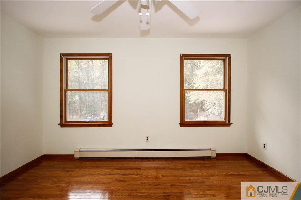 53 Hillsdale Road Edison, NJ 08820 - Photo 20 of 25 an empty room with wooden floor and windows