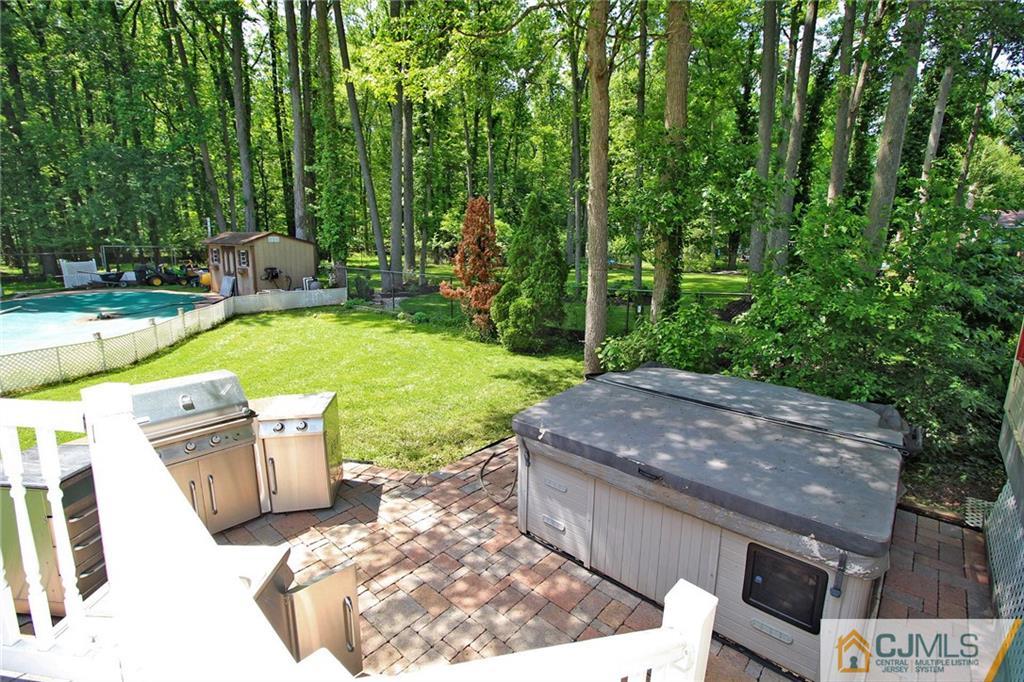 53 Hillsdale Road Edison, NJ 08820 - Photo 21 of 25 a view of a backyard with plants and outdoor seating