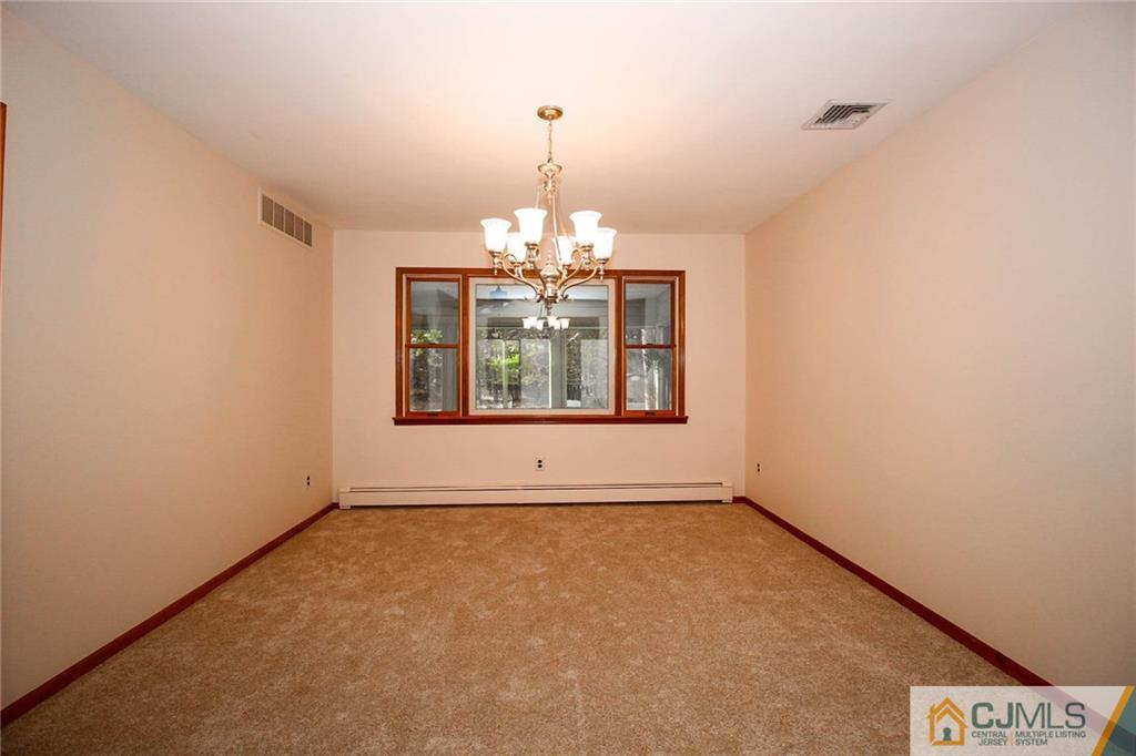 53 Hillsdale Road Edison, NJ 08820 - Photo 6 of 25 an empty room with windows and chandelier